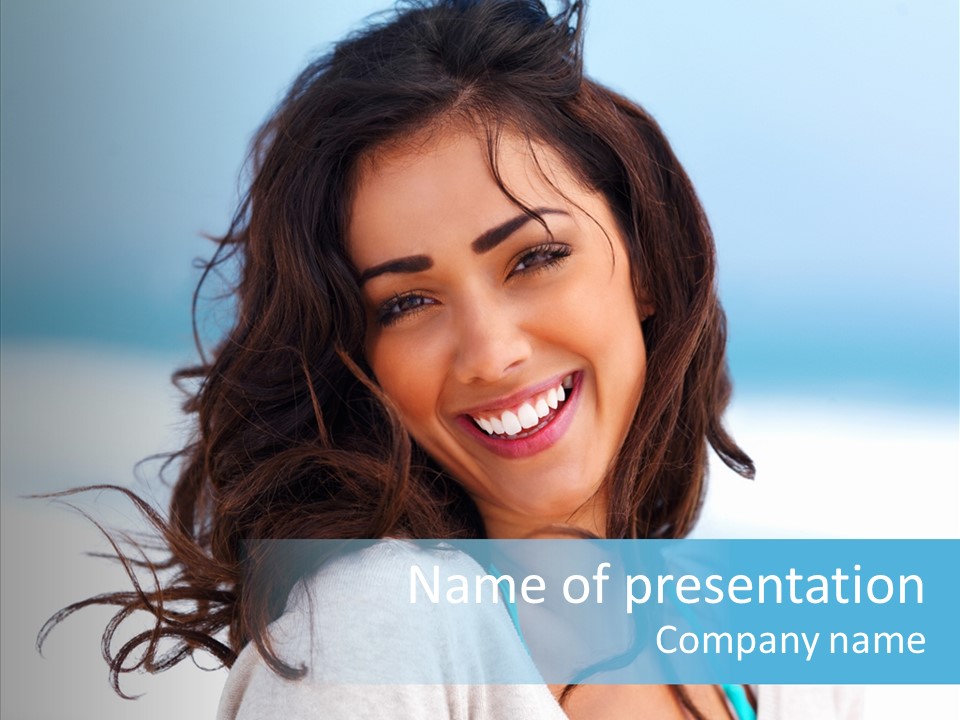 A Woman Smiling With Her Hair Blowing In The Wind PowerPoint Template