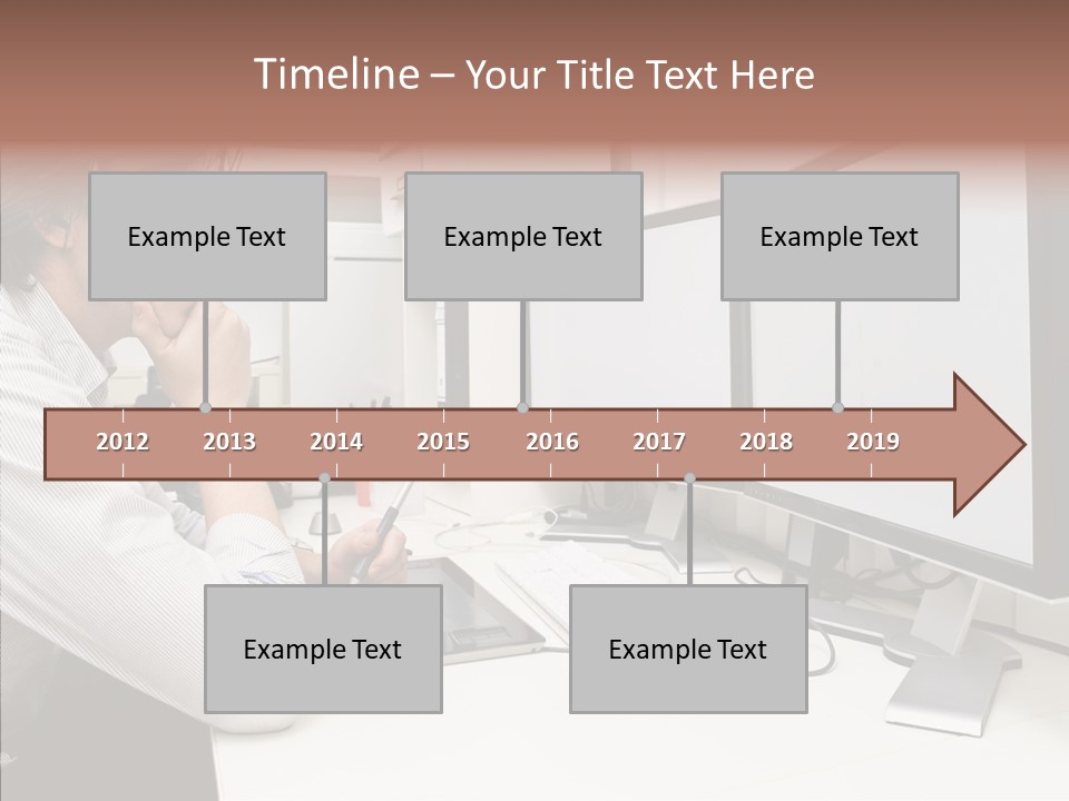 A Man Sitting At A Desk With A Computer PowerPoint Template