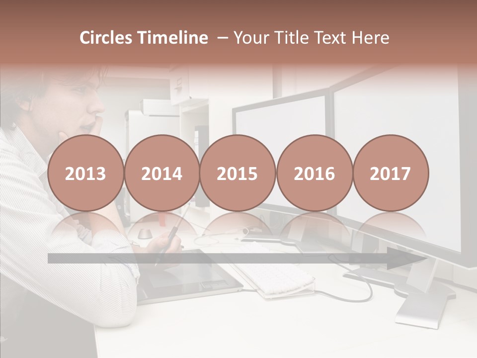 A Man Sitting At A Desk With A Computer PowerPoint Template