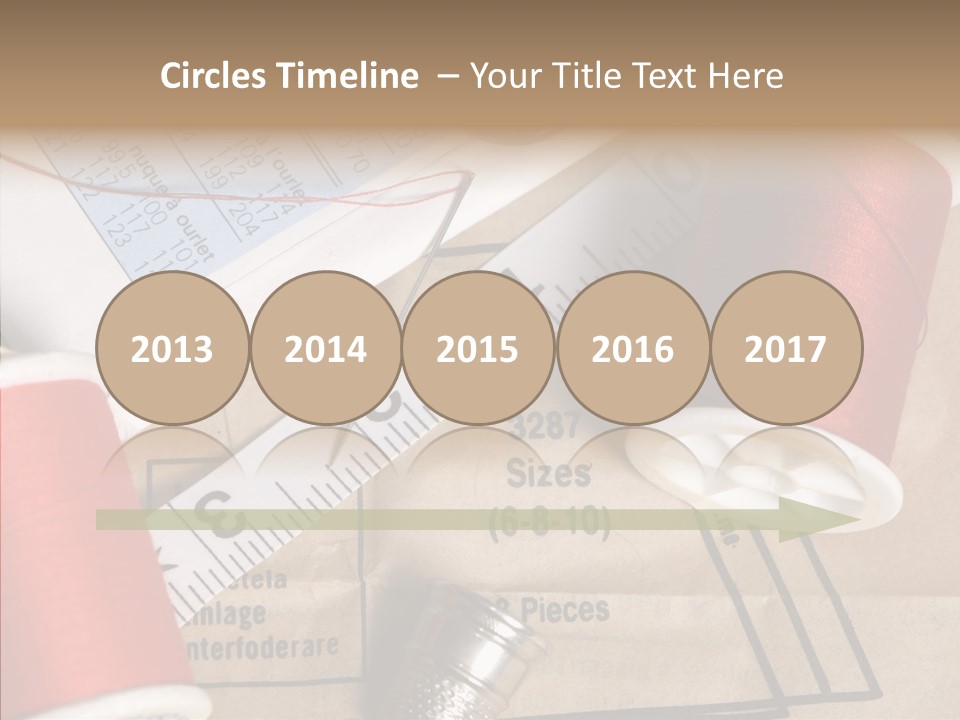 Two Spools Of Thread Sitting On Top Of A Piece Of Paper PowerPoint Template