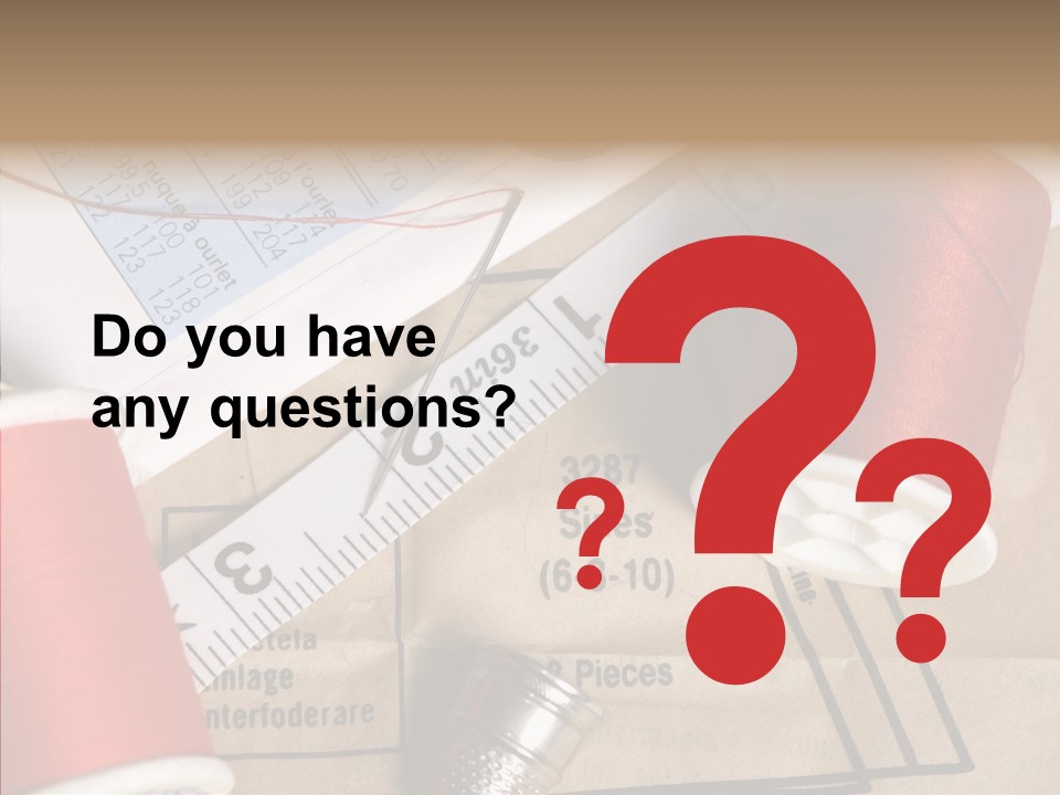 Two Spools Of Thread Sitting On Top Of A Piece Of Paper PowerPoint Template