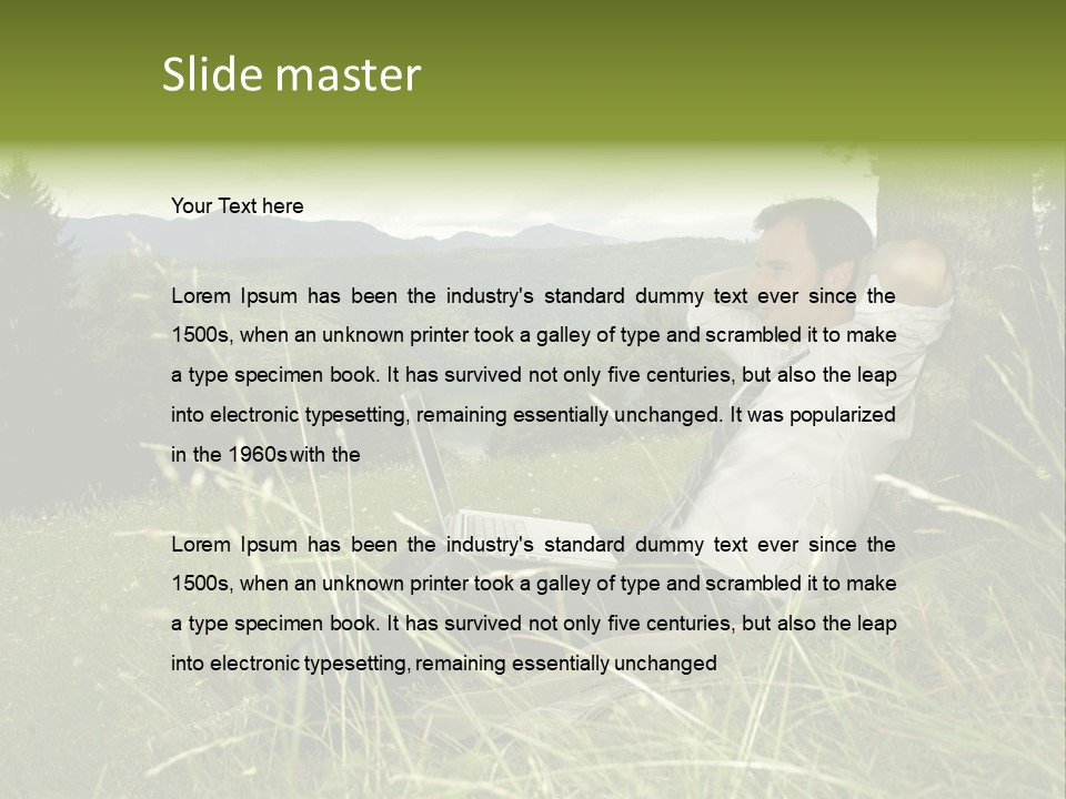 A Man Sitting In The Grass With A Laptop PowerPoint Template