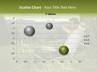 A Man Sitting In The Grass With A Laptop PowerPoint Template