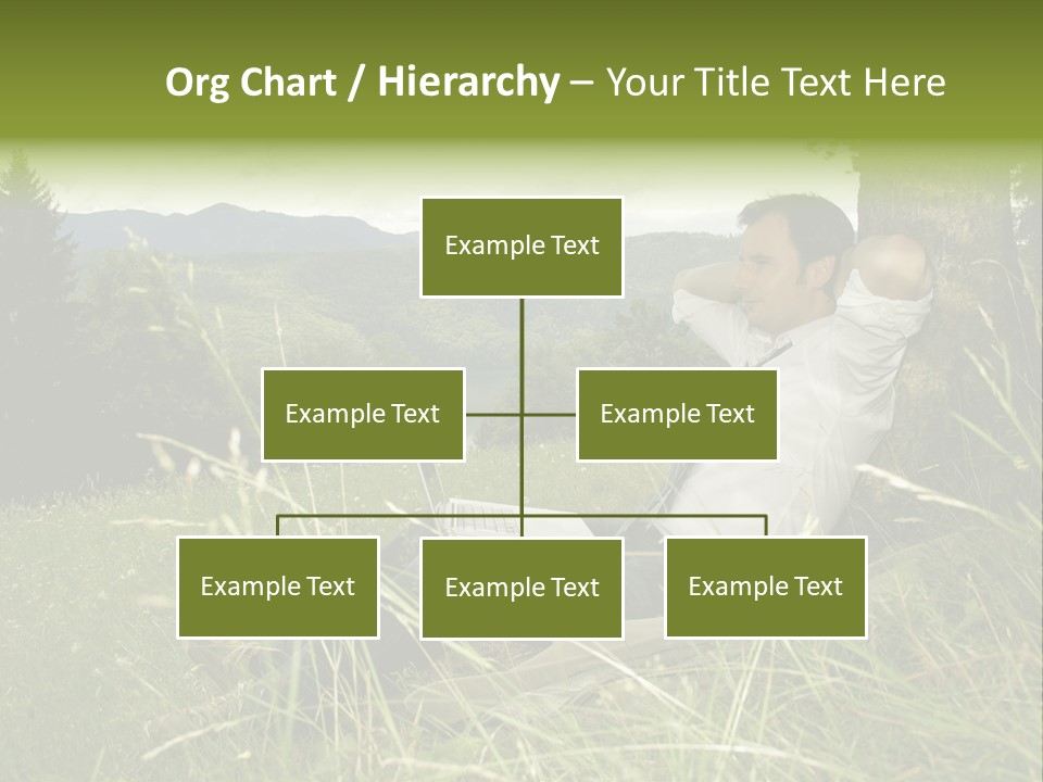 A Man Sitting In The Grass With A Laptop PowerPoint Template