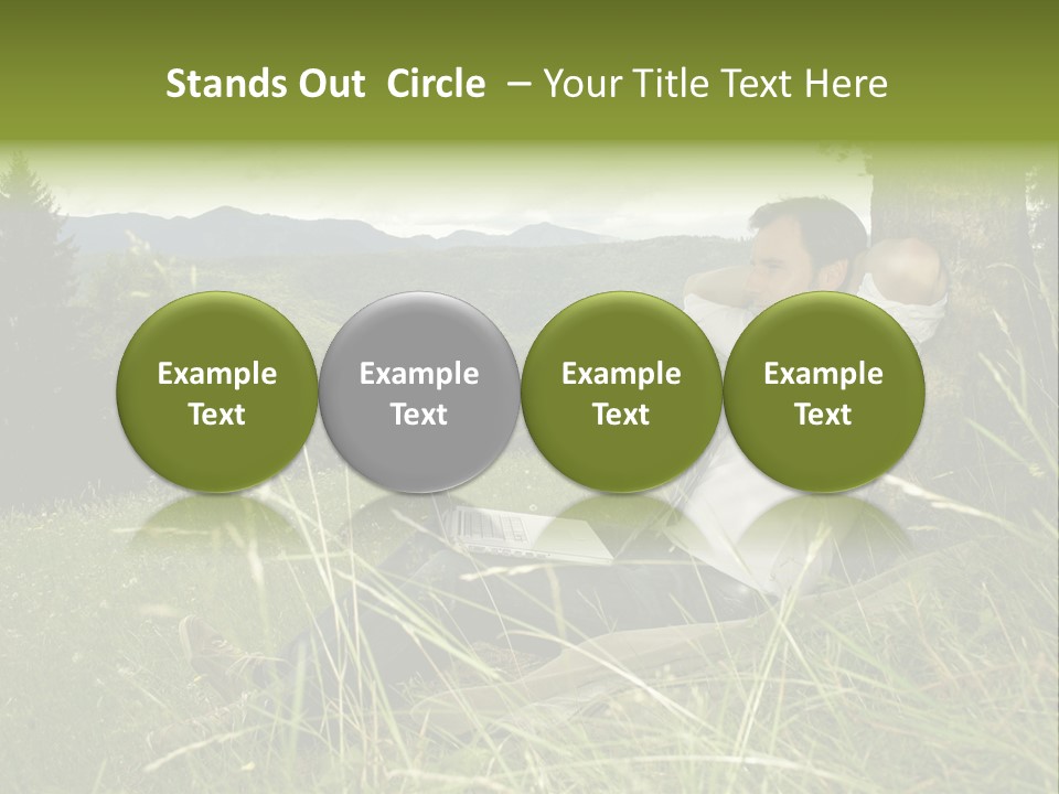 A Man Sitting In The Grass With A Laptop PowerPoint Template