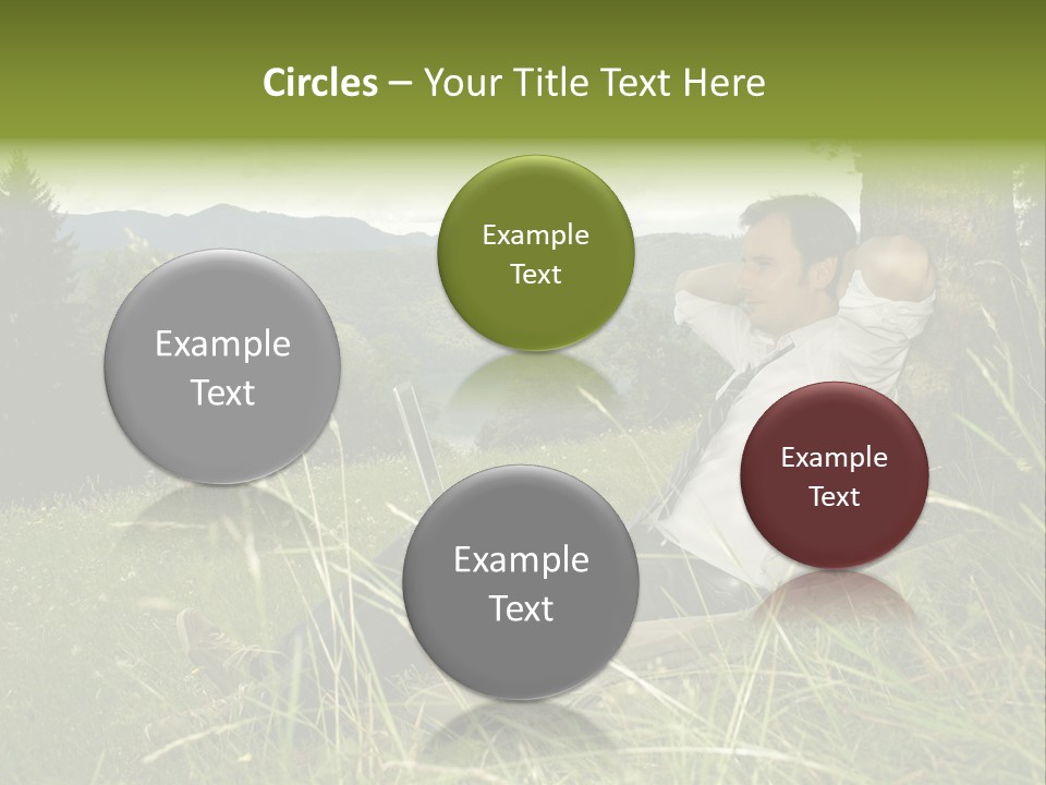 A Man Sitting In The Grass With A Laptop PowerPoint Template