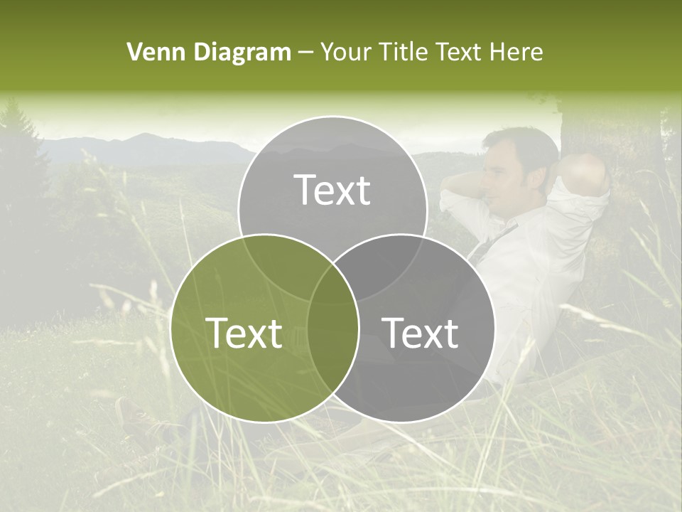A Man Sitting In The Grass With A Laptop PowerPoint Template