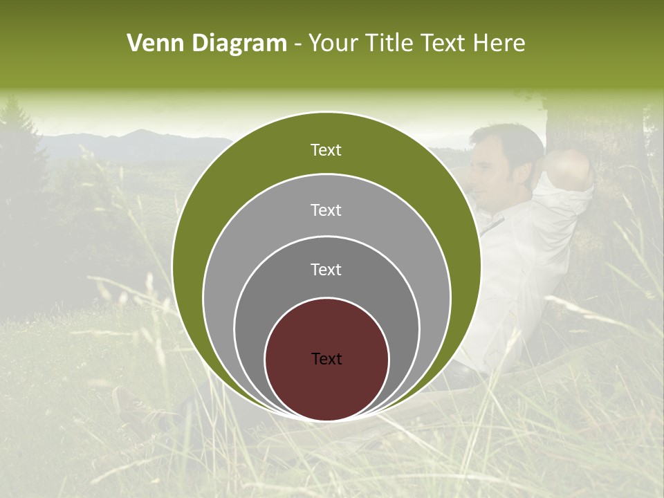 A Man Sitting In The Grass With A Laptop PowerPoint Template