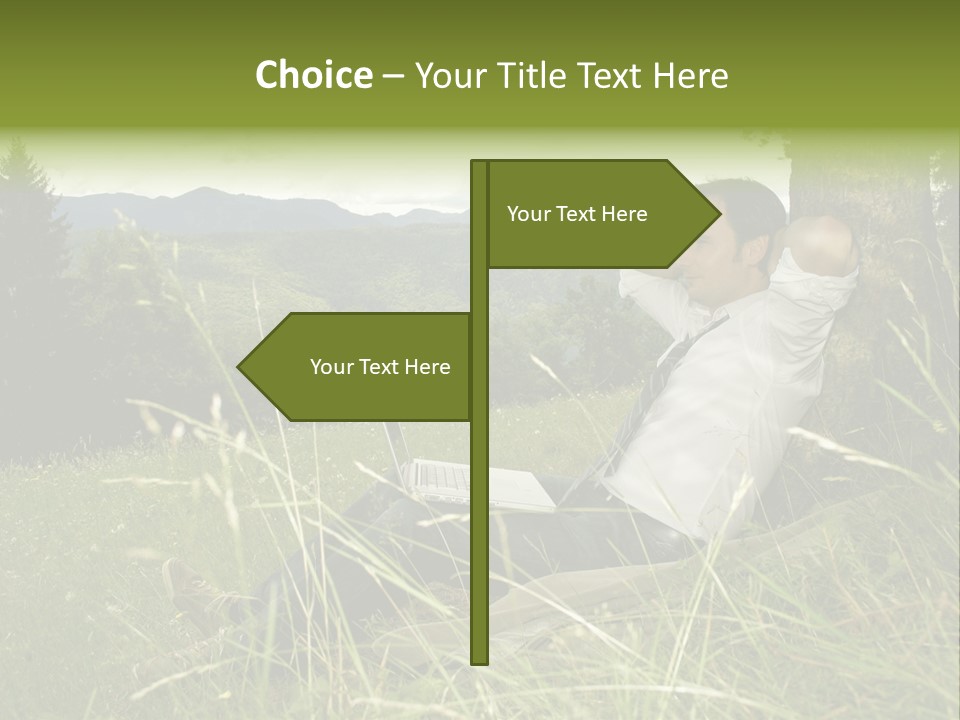 A Man Sitting In The Grass With A Laptop PowerPoint Template