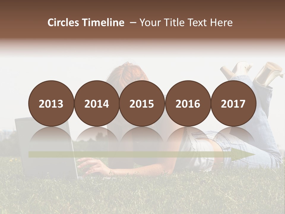 A Woman Laying On The Grass Using A Laptop PowerPoint Template