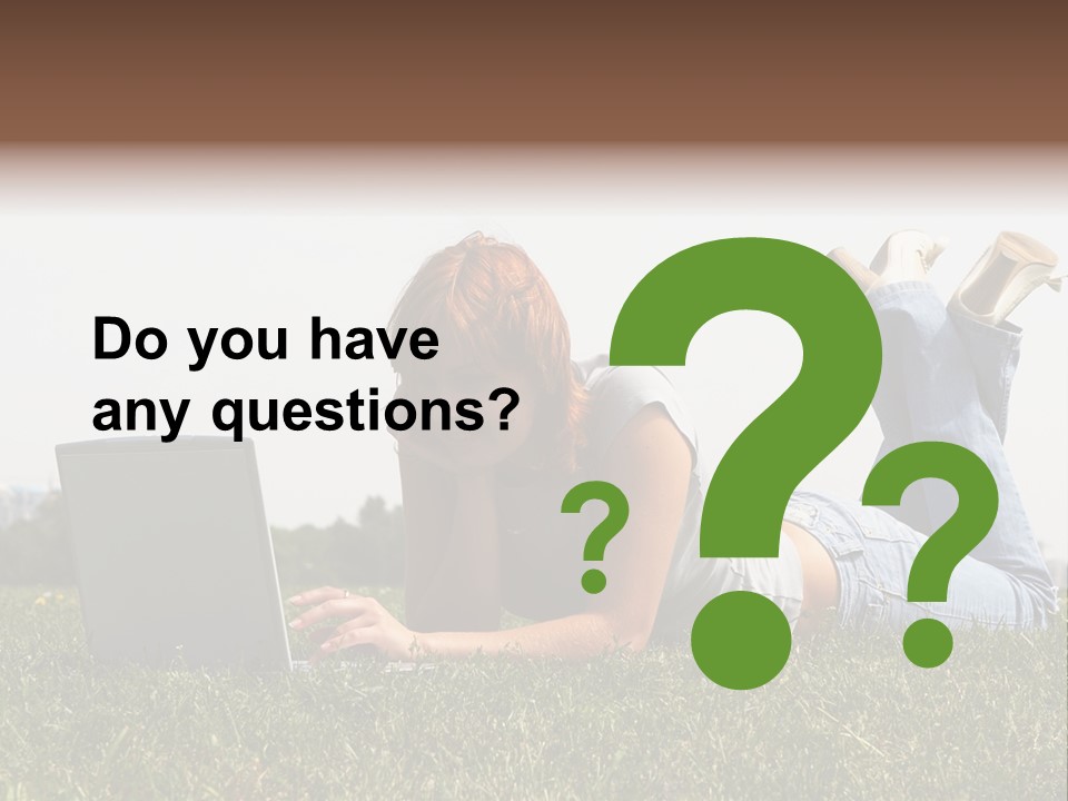 A Woman Laying On The Grass Using A Laptop PowerPoint Template