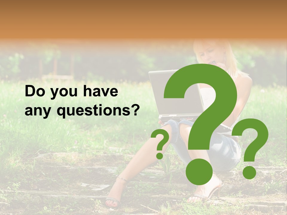 A Woman Sitting In The Grass Using A Laptop Computer PowerPoint Template