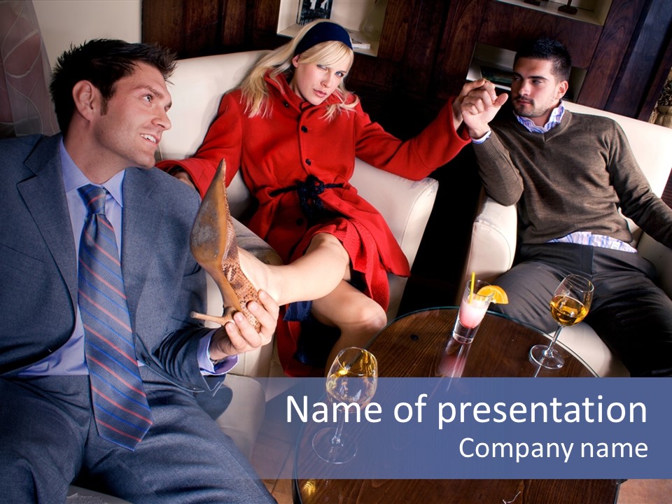 A Group Of People Sitting Around A Table PowerPoint Template