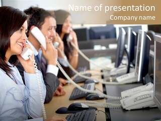 A Group Of People Sitting At A Desk Talking On Telephones PowerPoint Template