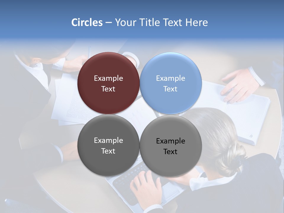 A Group Of People Sitting Around A Table Working On Laptops PowerPoint Template