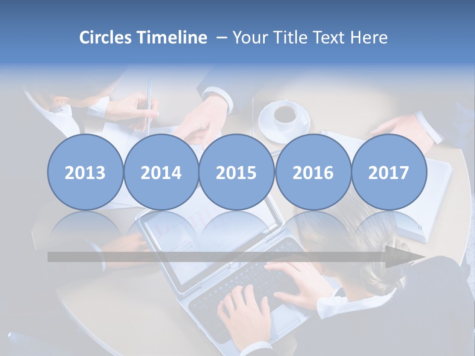 A Group Of People Sitting Around A Table Working On Laptops PowerPoint Template