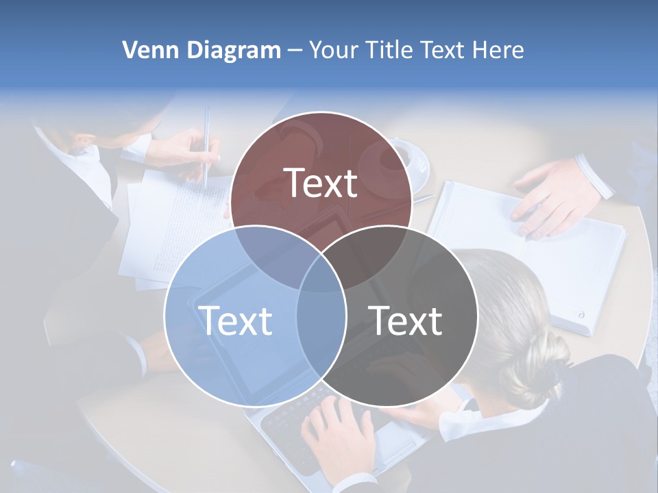 A Group Of People Sitting Around A Table Working On Laptops PowerPoint Template