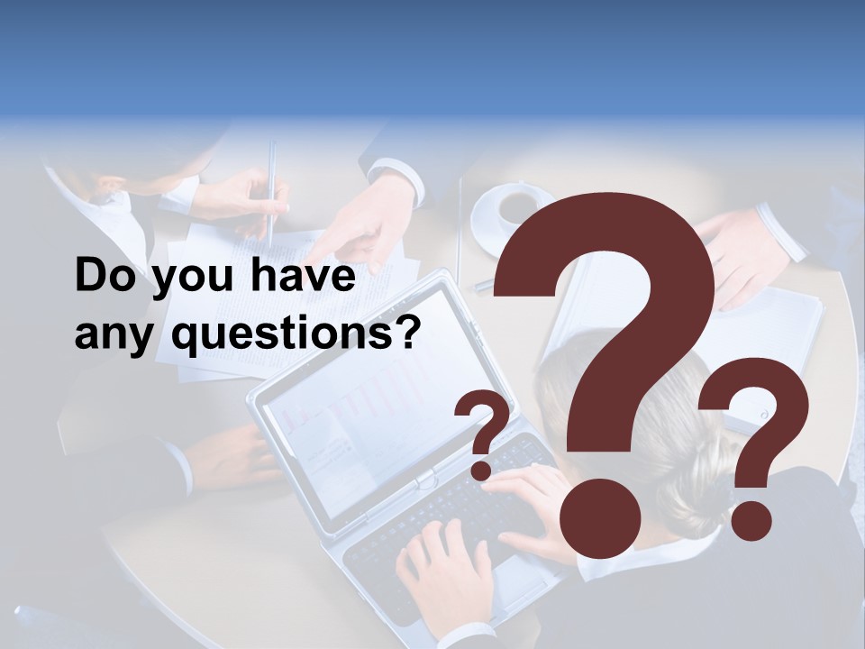 A Group Of People Sitting Around A Table Working On Laptops PowerPoint Template