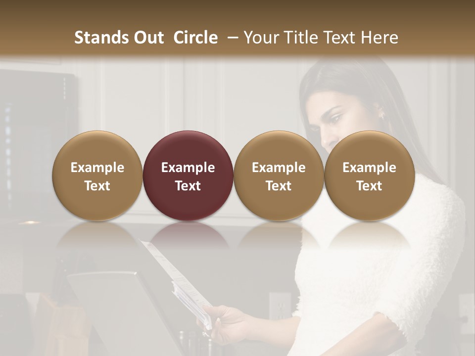 A Woman Using A Laptop Computer In A Kitchen PowerPoint Template