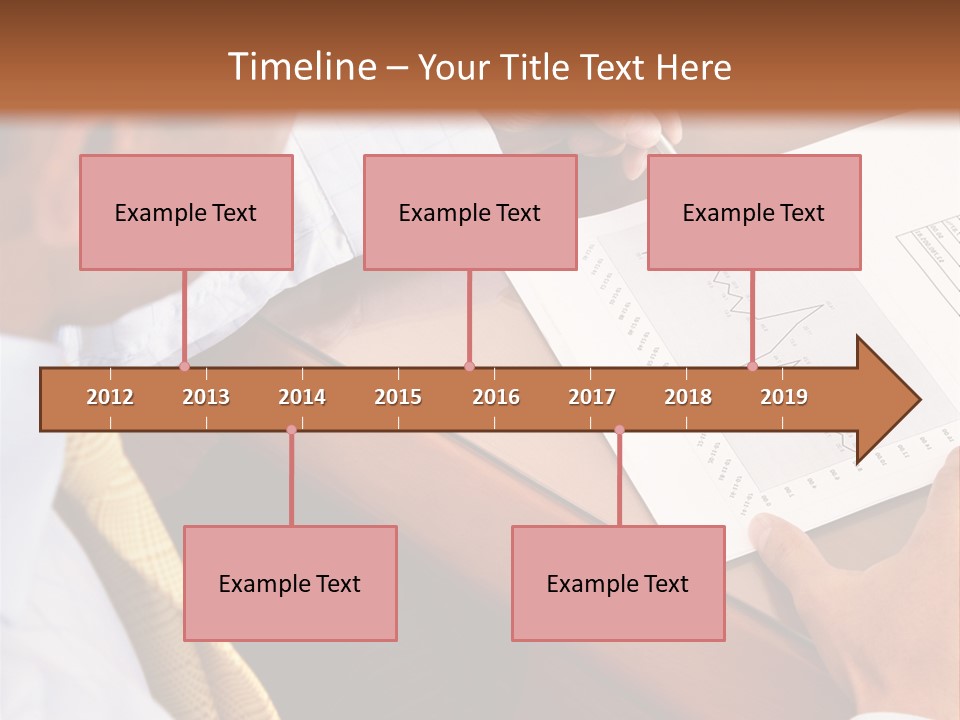 A Man Sitting At A Desk Writing On A Piece Of Paper PowerPoint Template