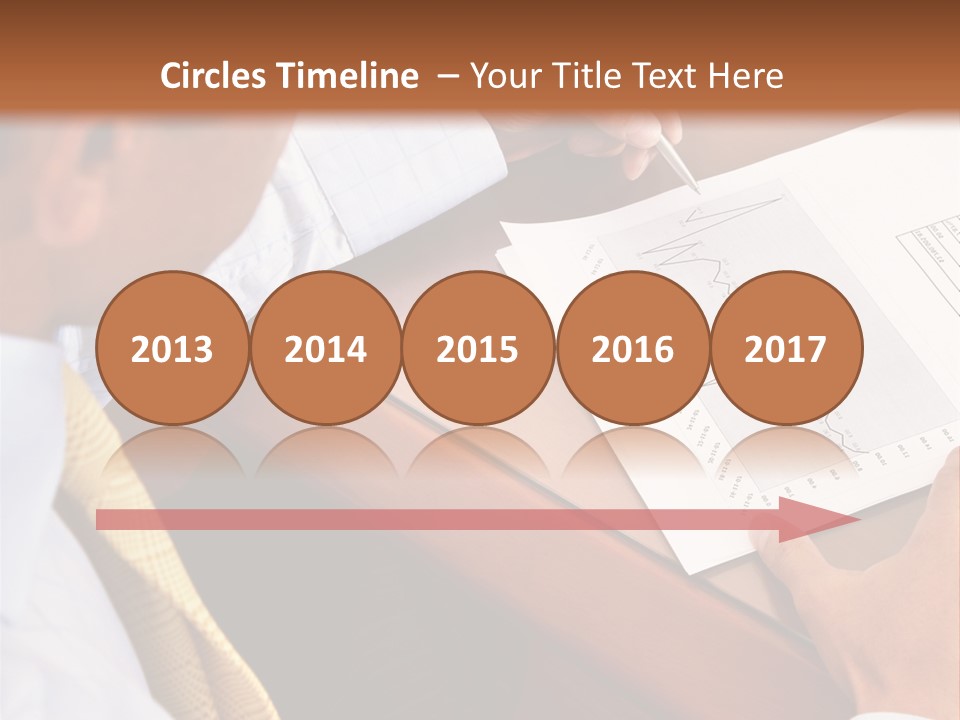 A Man Sitting At A Desk Writing On A Piece Of Paper PowerPoint Template