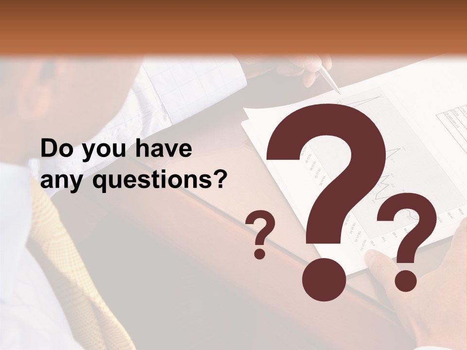 A Man Sitting At A Desk Writing On A Piece Of Paper PowerPoint Template