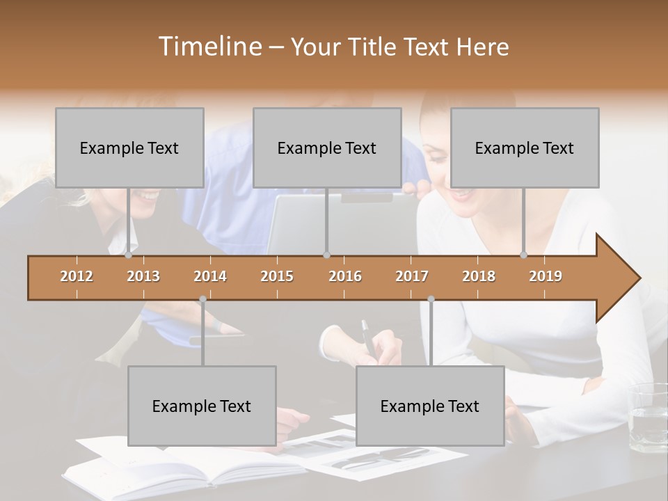 A Group Of People Sitting Around A Table With A Laptop PowerPoint Template
