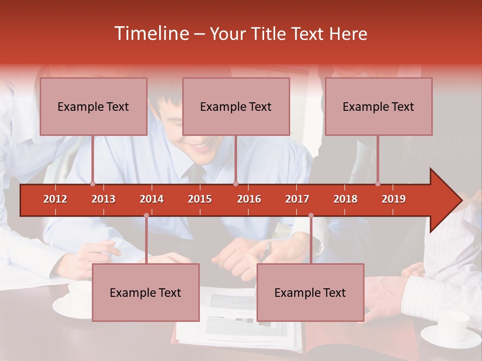A Group Of People Sitting Around A Table Working On A Piece Of Paper PowerPoint Template