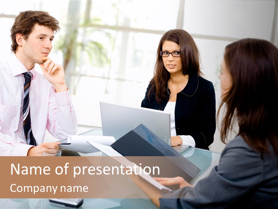 A Group Of People Sitting Around A Table With Laptops PowerPoint Template