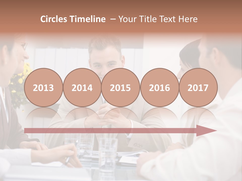 A Group Of People Sitting Around A Table Talking PowerPoint Template