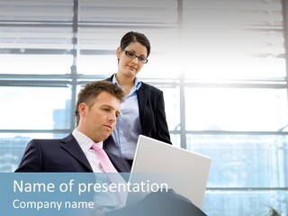 A Man And A Woman Looking At A Laptop PowerPoint Template