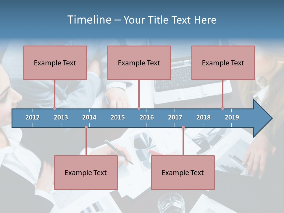 A Group Of People Sitting Around A Wooden Table PowerPoint Template