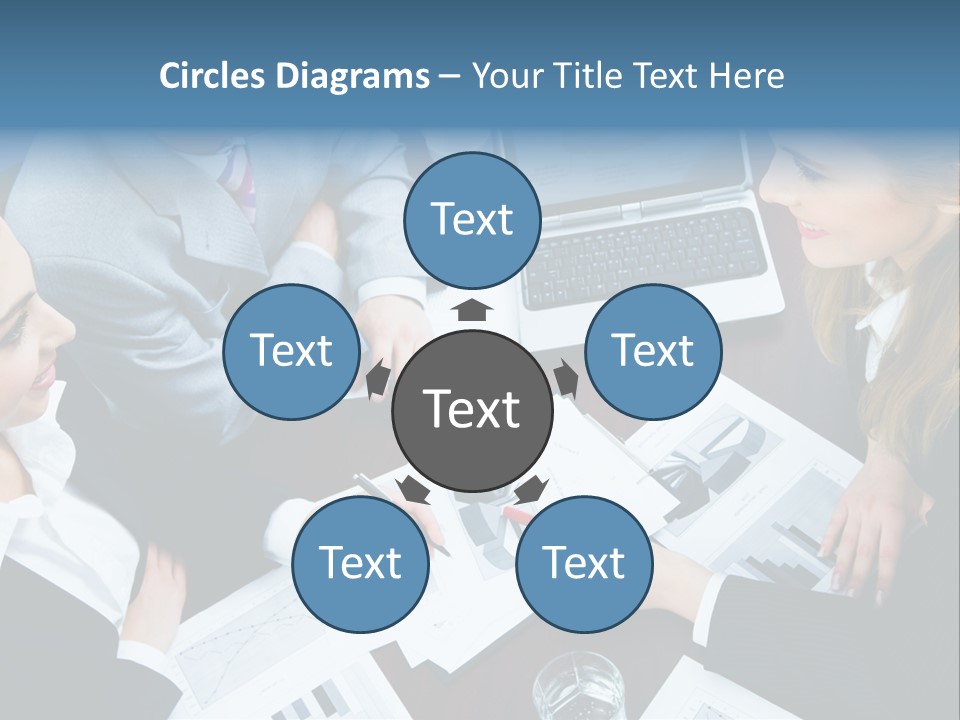 A Group Of People Sitting Around A Wooden Table PowerPoint Template