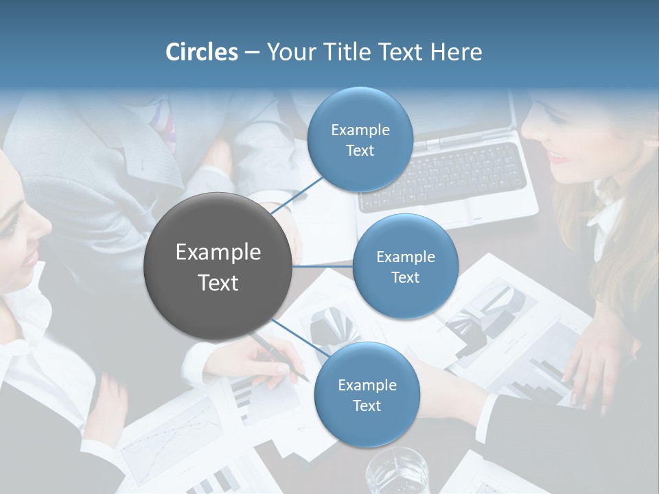 A Group Of People Sitting Around A Wooden Table PowerPoint Template