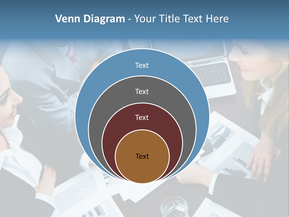 A Group Of People Sitting Around A Wooden Table PowerPoint Template