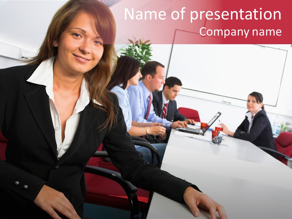 A Woman Sitting At A Table In Front Of A Group Of People PowerPoint Template