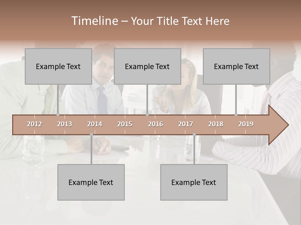 A Group Of People Sitting Around A Conference Table PowerPoint Template