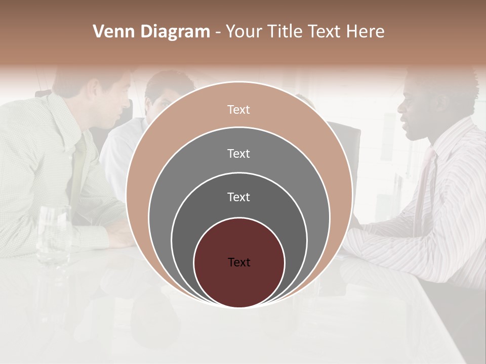A Group Of People Sitting Around A Conference Table PowerPoint Template