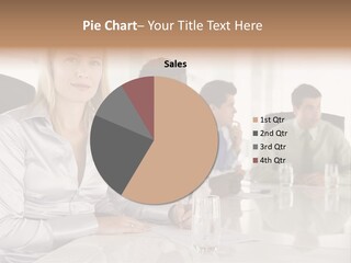 A Group Of People Sitting Around A Conference Table PowerPoint Template