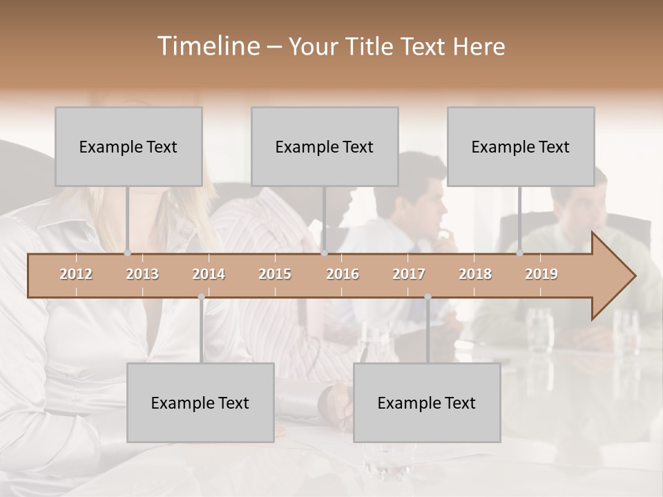 A Group Of People Sitting Around A Conference Table PowerPoint Template