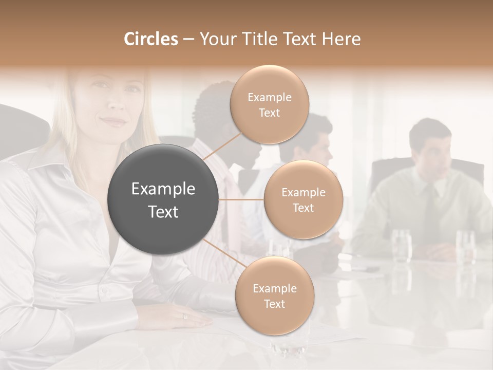 A Group Of People Sitting Around A Conference Table PowerPoint Template