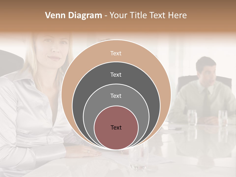 A Group Of People Sitting Around A Conference Table PowerPoint Template