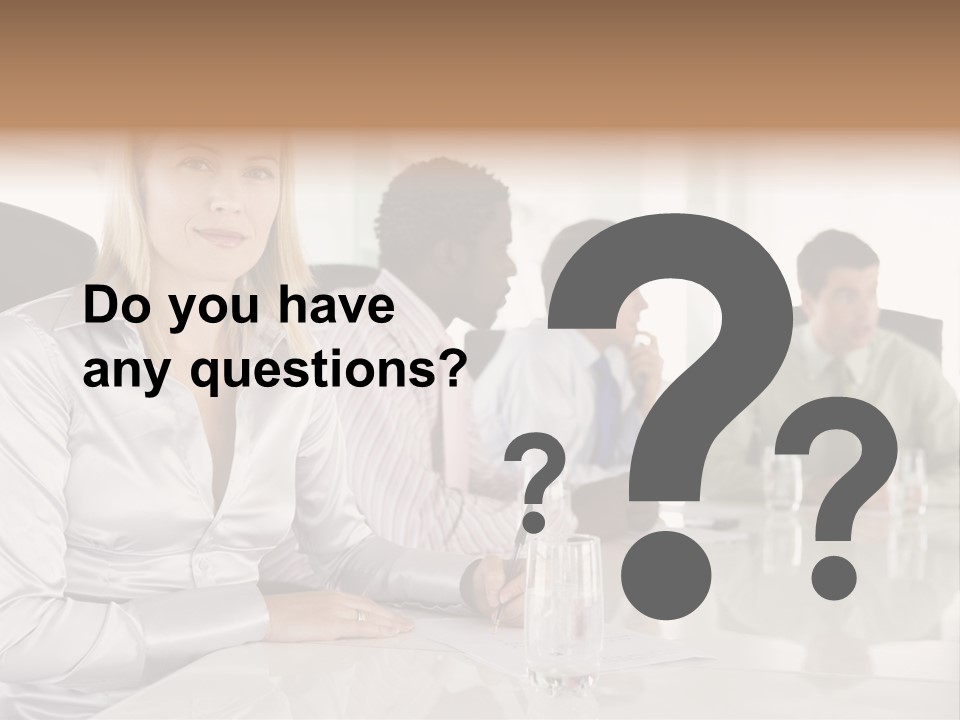 A Group Of People Sitting Around A Conference Table PowerPoint Template