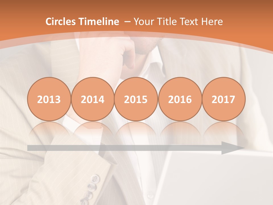 A Man Sitting In Front Of A Laptop Computer PowerPoint Template