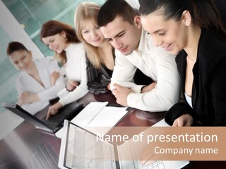 A Group Of People Sitting At A Table With Laptops PowerPoint Template