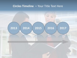 Two Women In Business Attire Looking At A Cell Phone PowerPoint Template