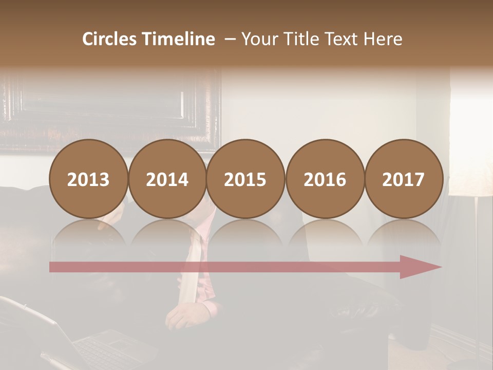 A Man Sitting On A Couch In A Living Room PowerPoint Template