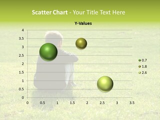 A Young Boy Sitting On The Grass In A Park PowerPoint Template