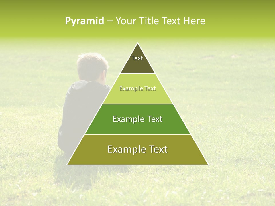 A Young Boy Sitting On The Grass In A Park PowerPoint Template