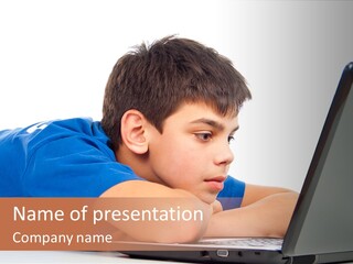 A Young Boy Laying On His Stomach Using A Laptop PowerPoint Template